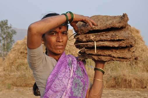 Indian woman preparing food - chapati, flatbread, desert village, India.