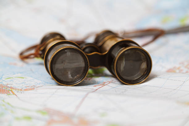Ancient binoculars are on map stock photo