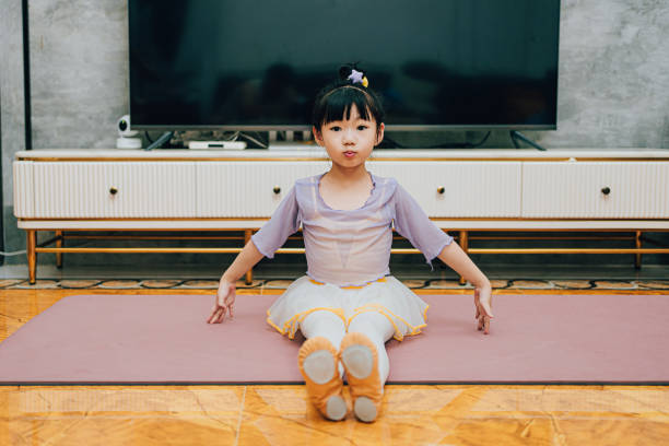 This little girl is dancing and stretching at home