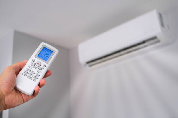 istock Man's hand using remote control open The air conditioner is cooled to 25 degrees Celsius in his bedroom. Health concepts and energy savings 1626980307