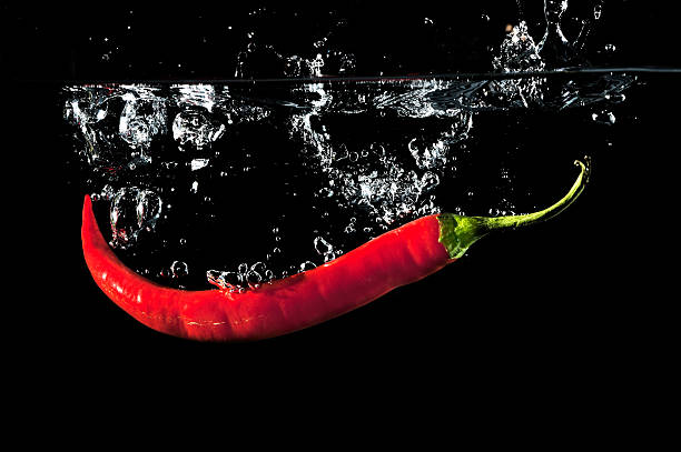 istock Red Peppers  Splashing In Water 162698267