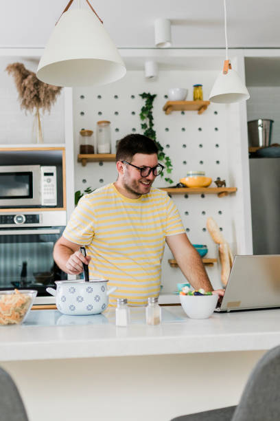 istock Portrait of a young man preparing meal in the kitchen 1627005777