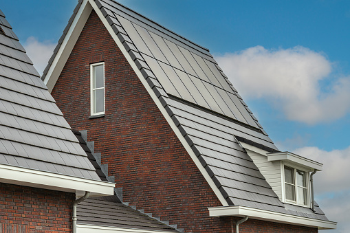 integrated solar modules in the pointed gable roof of a detached house
