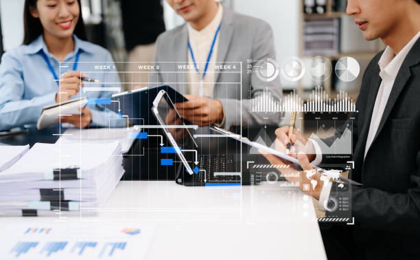 istock Business team hand Project manager working and update tasks and Gantt chart scheduling virtual diagram.with smart phone, tablet and laptop in office. 1627009155