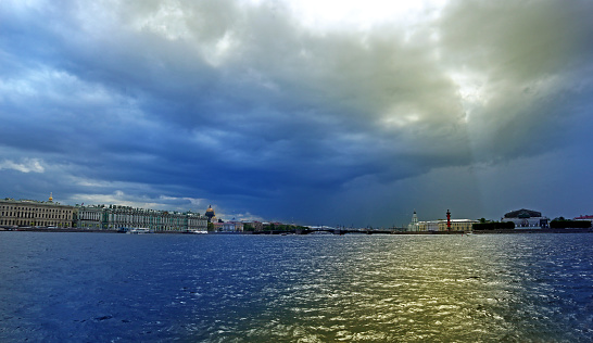 Beautiful view of the Palace bridge and water surface on a cloudy sky background. St. Petersburg, Russia - August 04, 2023