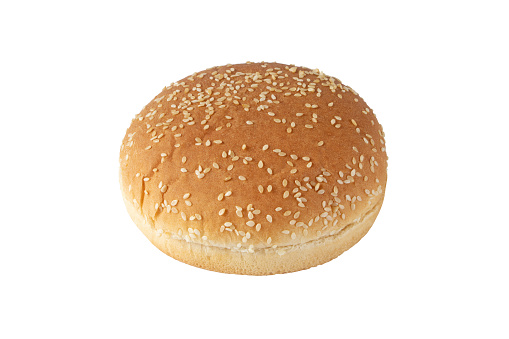 Sesame bun for burger isolated on white. Round bread topped with sesame seeds cut in half.