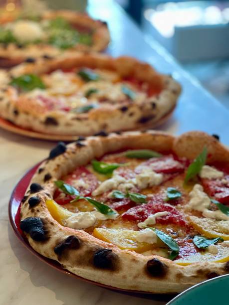 istock Italian pizza with fresh tomato and basil herb 1627038191
