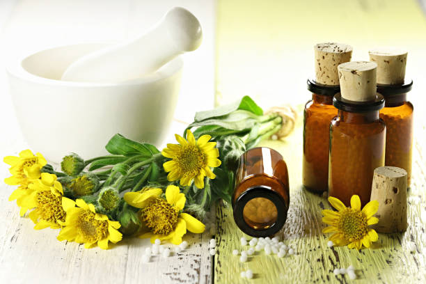 istock homeopathic arnica pills in brown bottles 1627046014