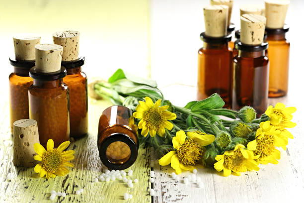 istock homeopathic arnica pills in brown bottles 1627046554
