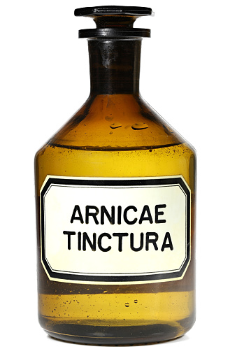 pharmacy bottle with arnica tincture isolated on white background