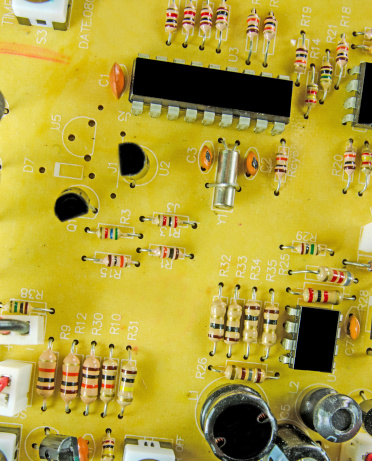 A  electrical circuit board with resistors and transistors.