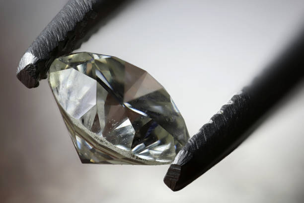 istock 0.45 ct brilliant cut diamond held by tweezers 1627048303