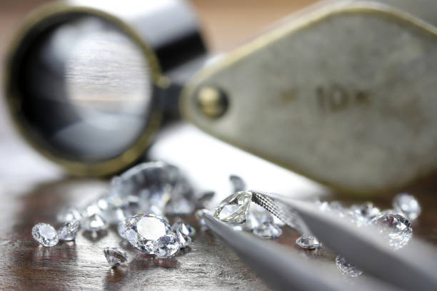 istock brilliant cut diamond held by tweezers 1627050056