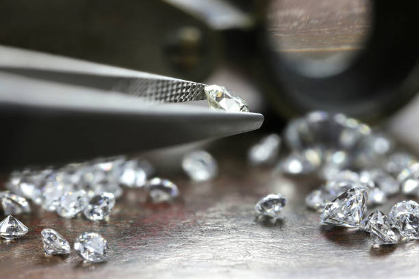 istock brilliant cut diamond held by tweezers 1627050285