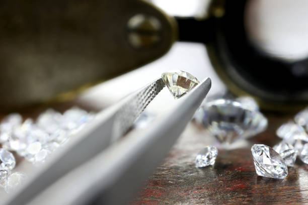 istock brilliant cut diamond held by tweezers 1627050606