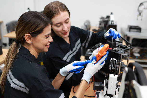 istock Caucasian two young female engineers learning robotic arm in training class together, innovation and development smart 4.0 factory concept. 1627053402