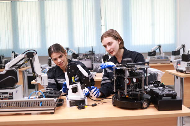 istock Caucasian two young female engineers learning robotic arm in training class together, innovation and development smart 4.0 factory concept. 1627053403