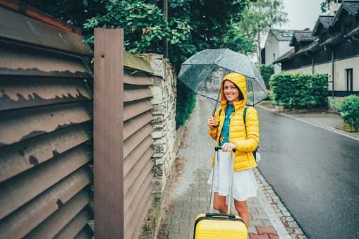 Woman with suitcase relocate to live in Krakow