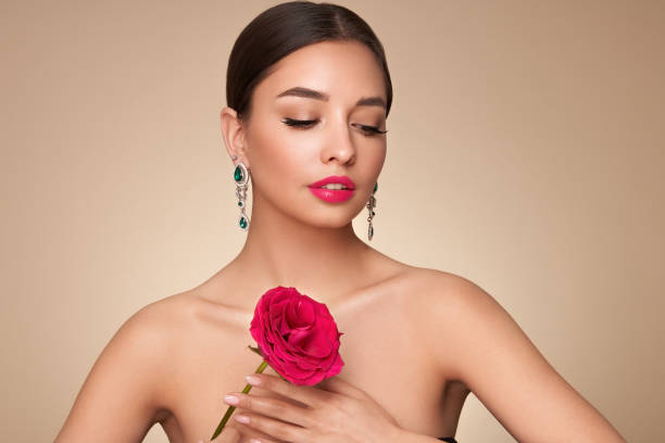 istock Beautiful young woman a rose flower 1627057334