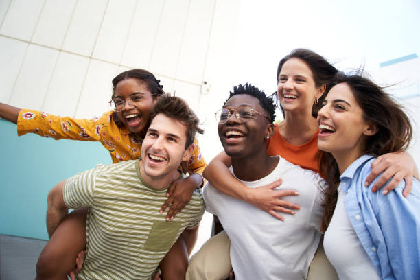 istock Group of students celebrating and hugging in piggyback 1627060665
