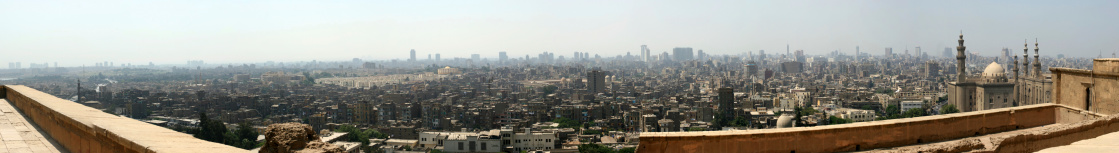 A panoramic view of Cairo, Egypt, from the Citadel with the Pyramids visible in the background.