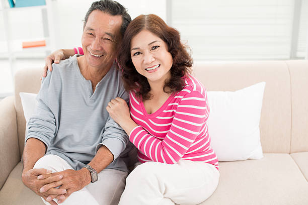 Candid couple Portrait of cheerful pensioners enjoying their home life vietnamese old man portrait stock pictures, royalty-free photos & images