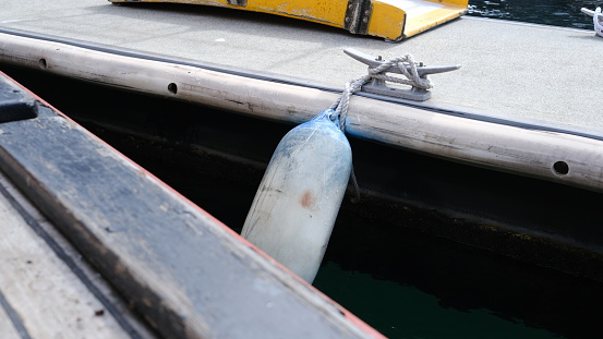 In boating, a fender is an air-filled ball or a device in other shape and material used to absorb the kinetic energy of a boat or vessel berthing against a jetty, quay wall or other vessel.