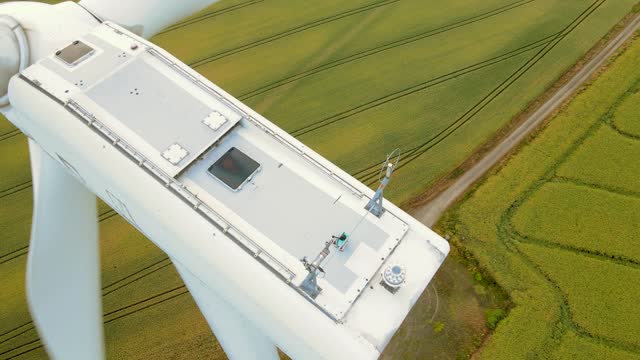 Close up elements of Large wind turbine with rotating blades generate green energy in field
