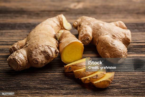 Fresh Ginger Whole And Chopped On Rustic Wood Surface Stock Photo - Download Image Now