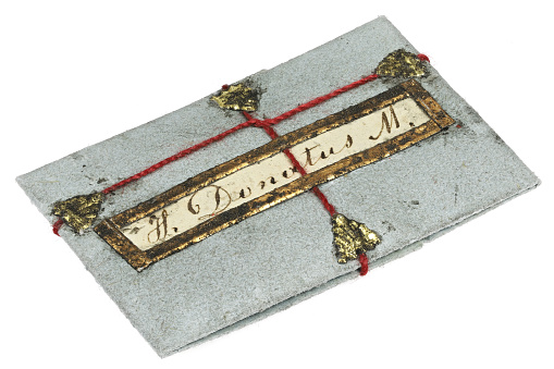 folded paper relic to Saint Donatus isolated on white background