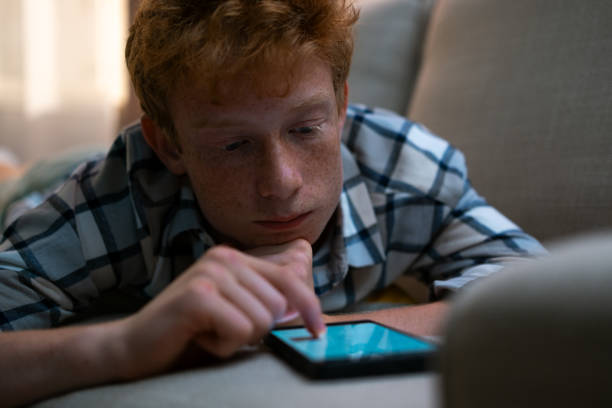 istock Sad boy with smart phone 1627122097
