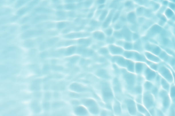 istock Blue water with ripples on the surface. Defocus blurred transparent blue colored clear calm water surface texture with splashes and bubbles. Water waves with shining pattern texture background. 1627122629
