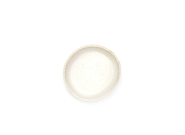 istock Top view, empty beige round ceramic bowl of sauce with dotted isolated on a white background. 1627131182