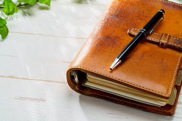istock Ring bound planner and pen on wooden table 1627135582