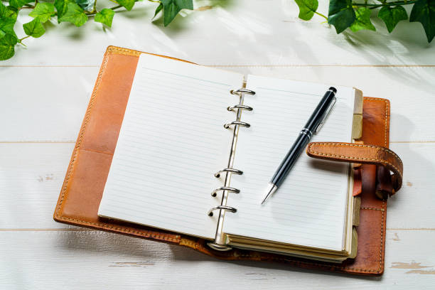 istock Ring bound planner and pen on wooden table 1627136117