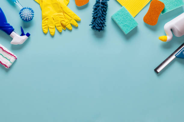 Different cleaning supplies on blue background with copy space top view Different cleaning supplies on a blue background with copy space top view cleaning product stock pictures, royalty-free photos & images