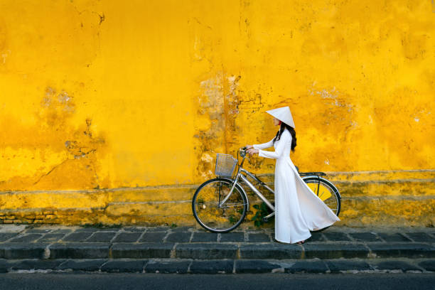Asian woman wearing vietnam culture traditional at Hoi an, Vietnam. Asian woman wearing vietnam culture traditional at Hoi an, Vietnam. ao dai stock pictures, royalty-free photos & images