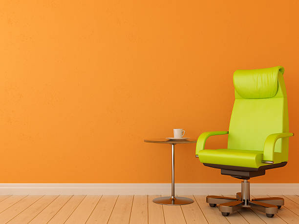 istock Green chair against orange wall 162714080