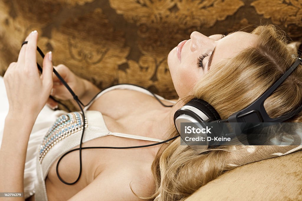 Listening music Pretty young girl listening music  Activity Stock Photo