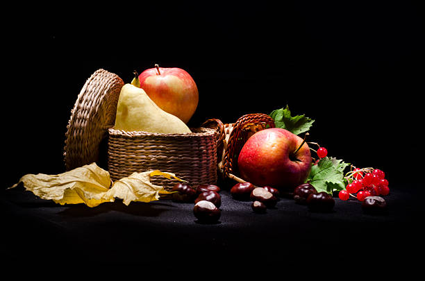 istock Still life with autumn fruits on black background 162714455