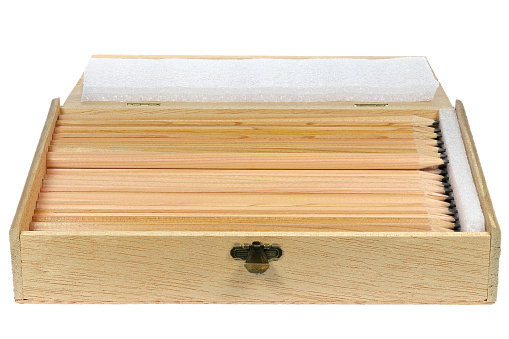 wooden box with pencils isolated on white background