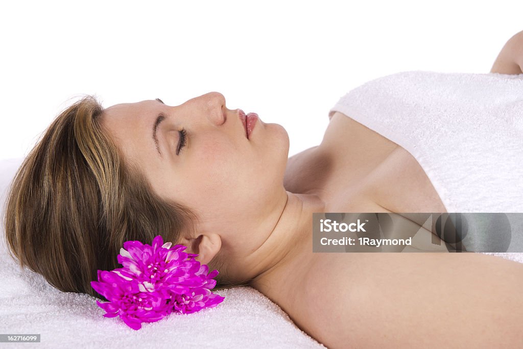 Woman at day spa aroma therapy massage table Spa therapy pretty young blond woman, implied nude enjoying aroma therapy covered with towel laying on massage table. In studio on white background. 20-24 Years Stock Photo