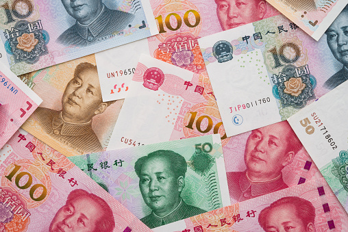 Chairman Mao (Mao Zedong) portrait on 100, 50, 20, 10 Chinese paper currency Yuan renminbi banknotes background. China or economy of Asia growth, financial business, US trade war, GDP slowdown concept.