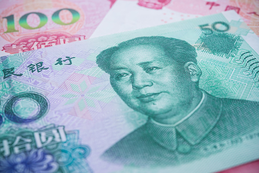 Chairman Mao (Mao Zedong) portrait on 50 Chinese paper currency Yuan renminbi banknotes background. China or economy of Asia slow growth, financial business, US trade war, Forex trading concept.