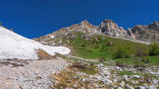 Glacier in the spring at the foot of the mountains. Vicinity of Mount Fisht in the Caucasus. Mountain landscapes.