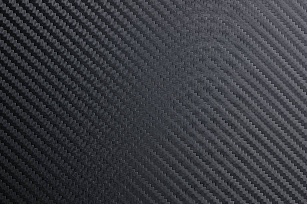 Carbon fiber material. Useful as texture. detailed tightly woven carbon fibre background texture. woven fabric photos stock pictures, royalty-free photos & images