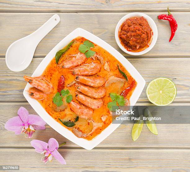 Overhead View Of Bowl Of Tom Yum Nam Khon On A Wooden Table Stock Photo - Download Image Now