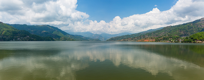 Pokhara is a beautiful city in Nepal with a serene lake called Phewa Lake and stunning views of the Annapurna mountain range. It's known for adventure activities like paragliding and trekking. The World Peace Pagoda offers panoramic views.