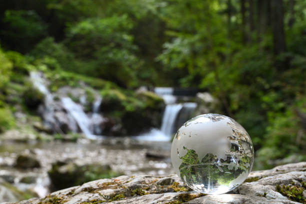 istock Glass globe and beautiful waterfall 1627210602