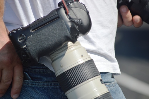 journalist with professional telephoto camera